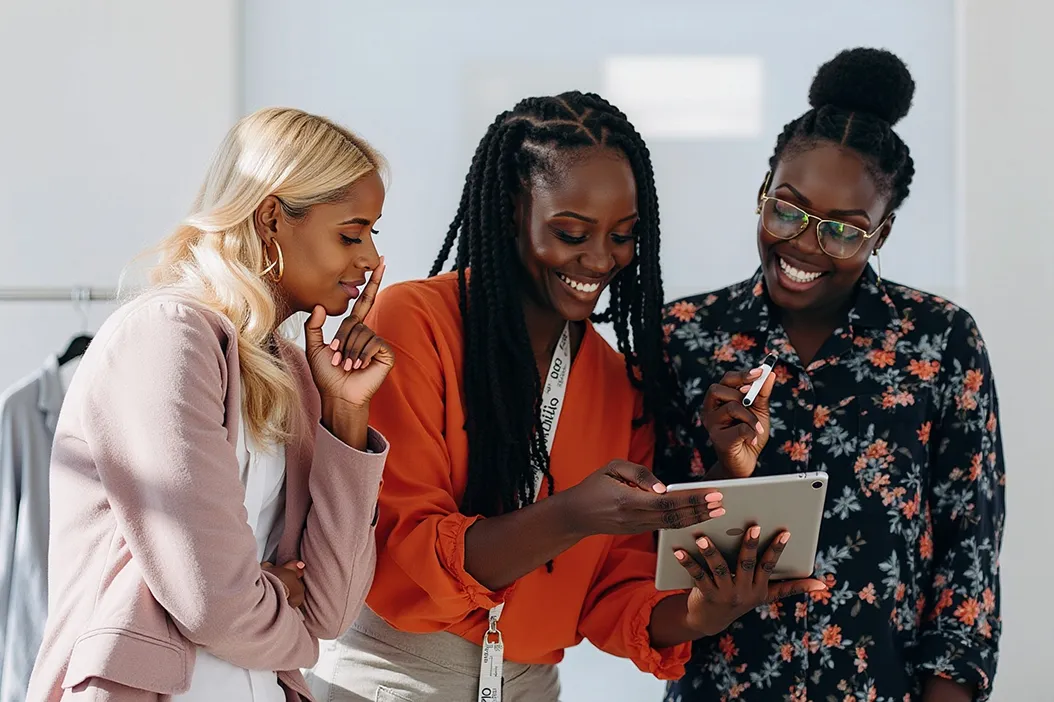Group of ladies using an application and smiling